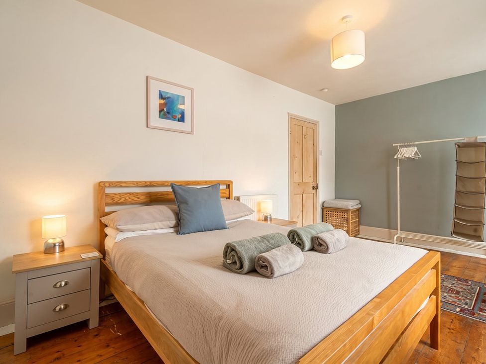 A bedroom with a bed and bedside table at The Old Barn in Manchester