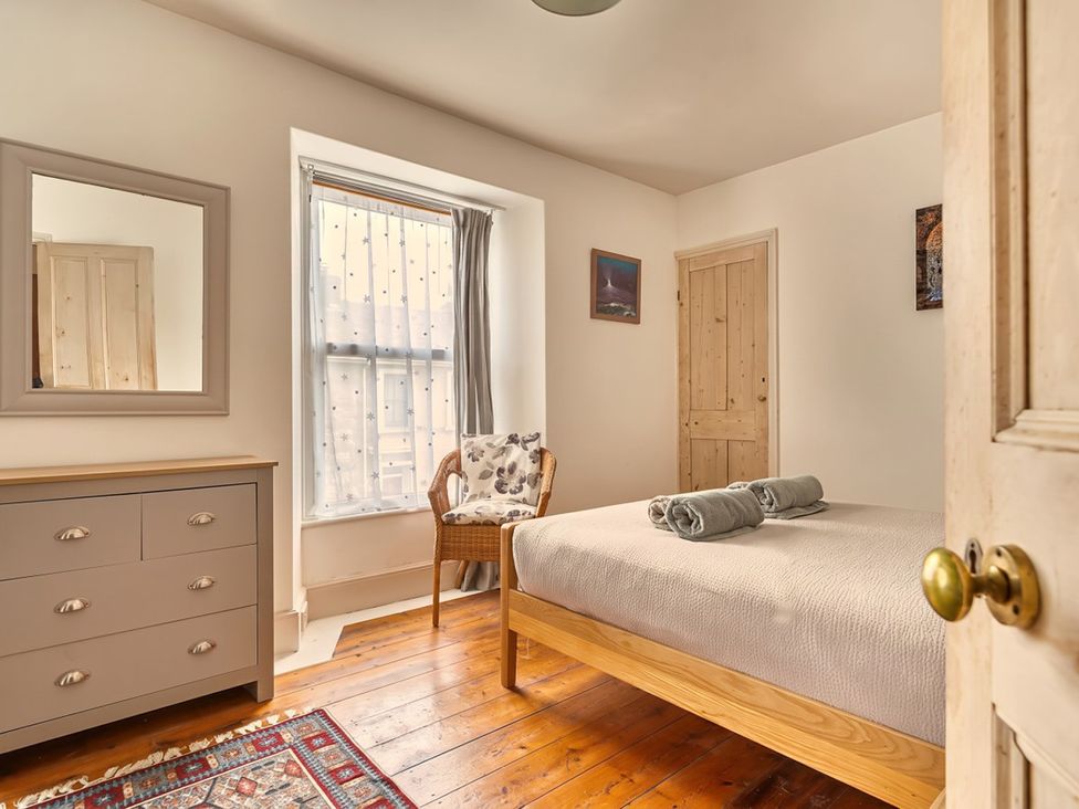 A bedroom with a bed and dresser at 