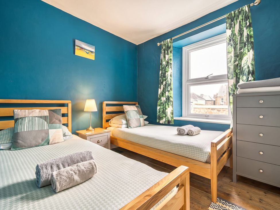 A bedroom with two beds and a window at 