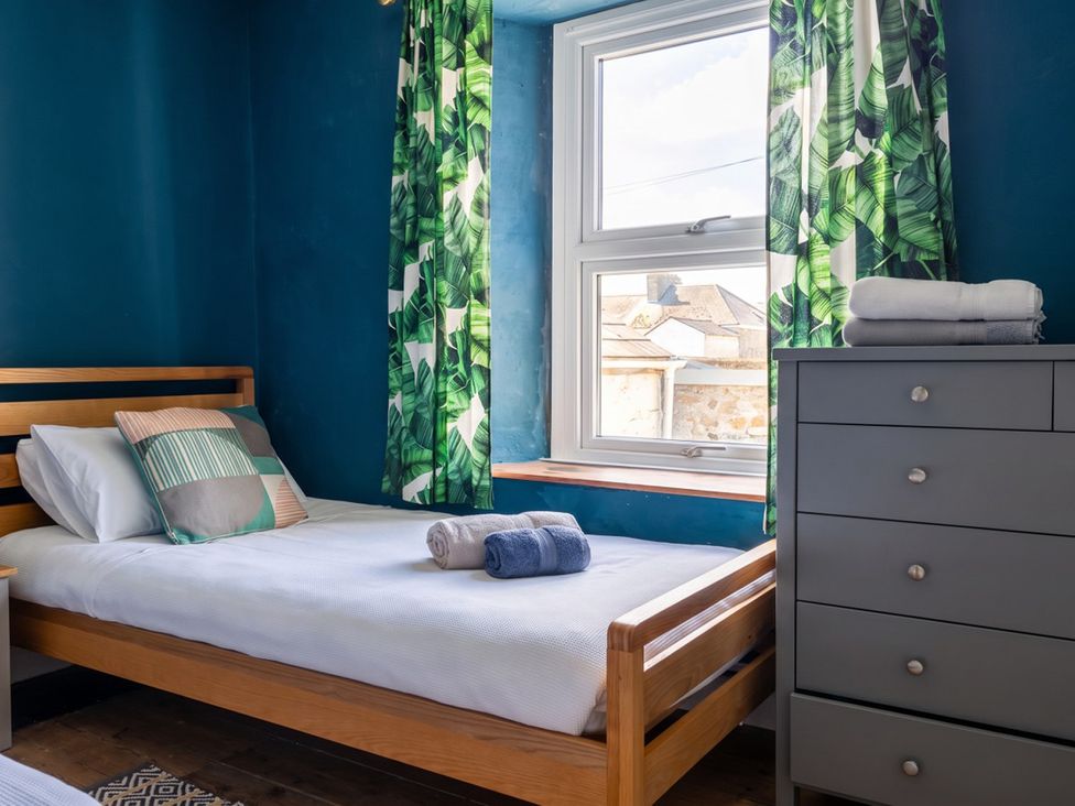 A bedroom with a bed and window at The Old Barn in Manchester
