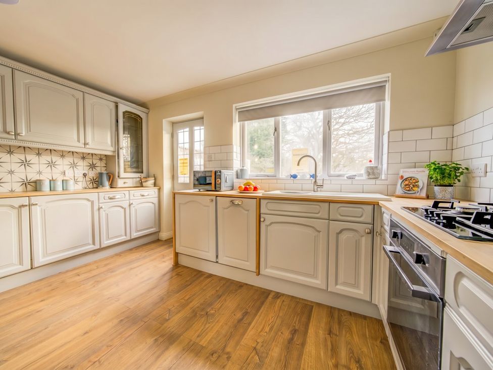A kitchen with cabinets and appliances at The Old Barn in Manchester