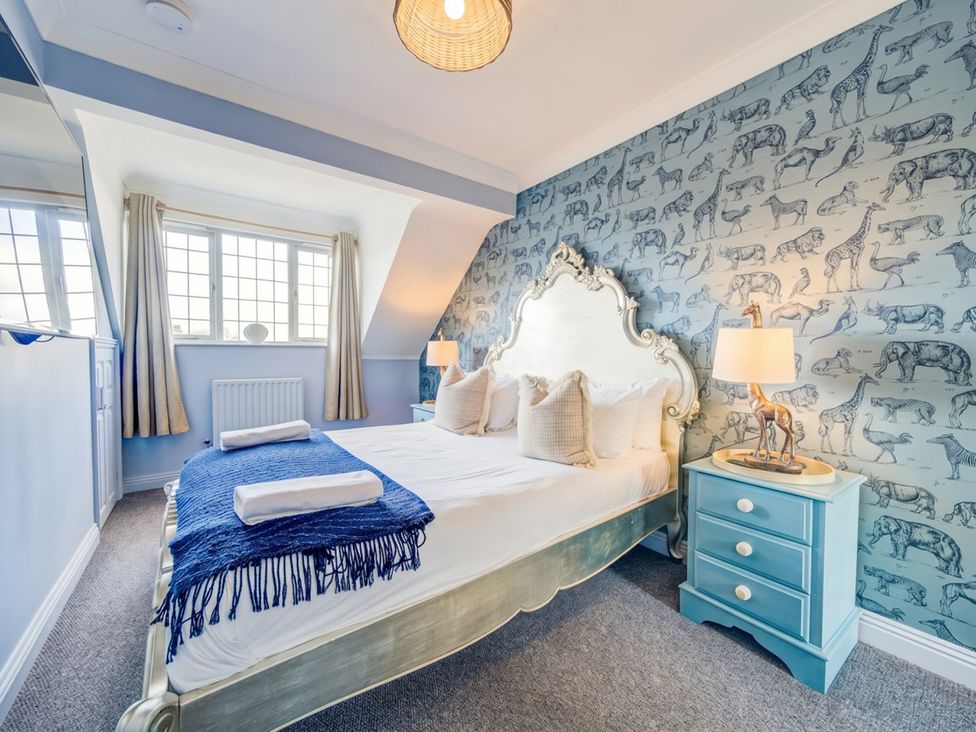 A bedroom with a bed and blue bedside table at The Old Barn in Manchester