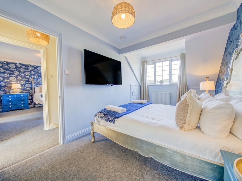A bedroom with a bed and television at The Old Barn in Manchester