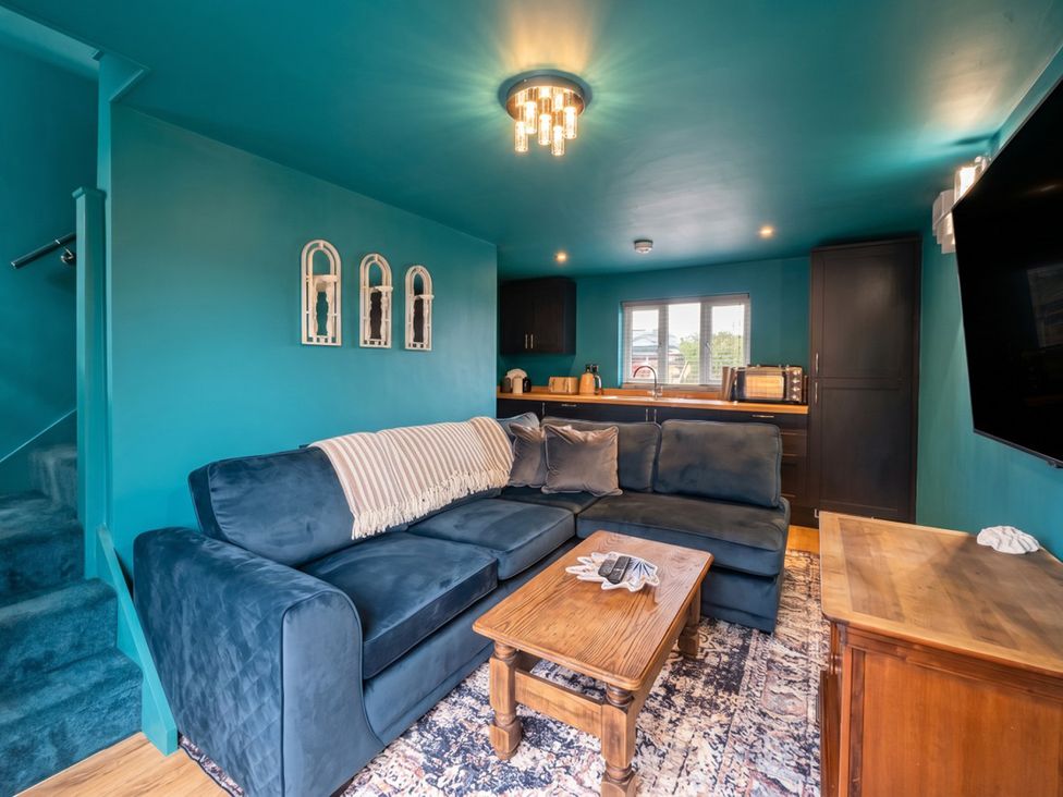 A living room with a sofa and a coffee table at The Old Barn in Manchester