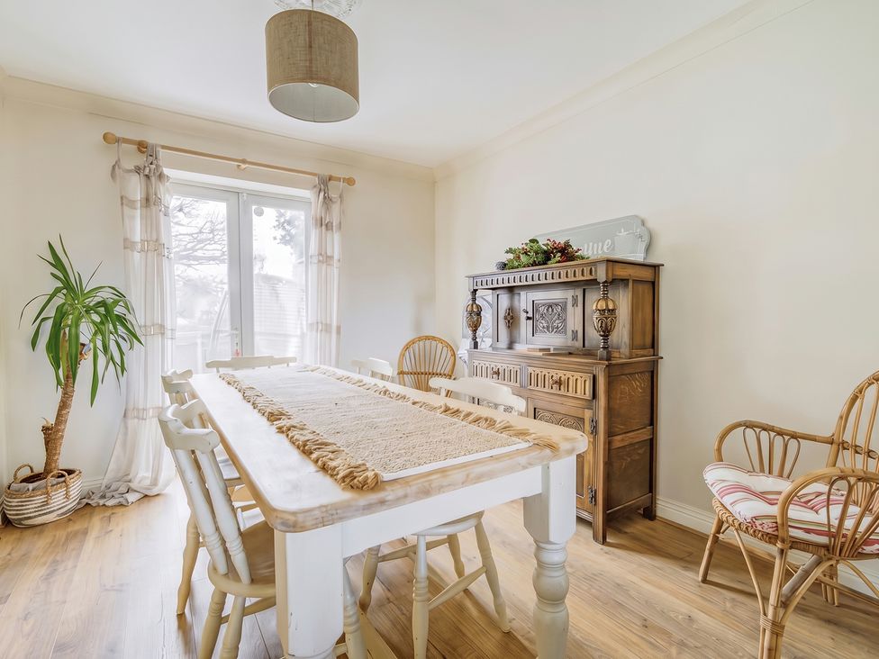 A dining room with a table and chairs at 