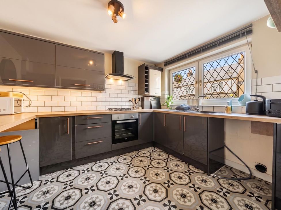 A kitchen with cabinets and appliances at The Old Barn in Manchester