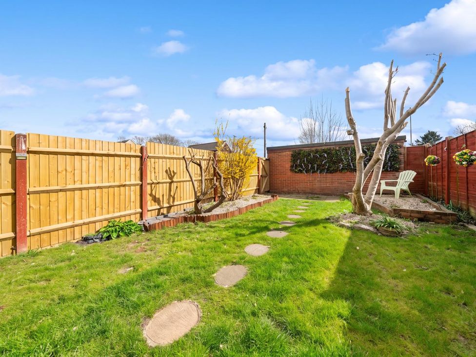A garden with a pathway and bench at a residential property