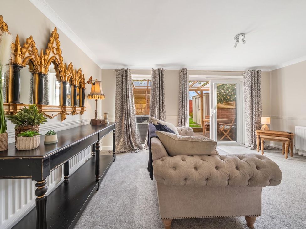 A living room with a sofa and table at a property