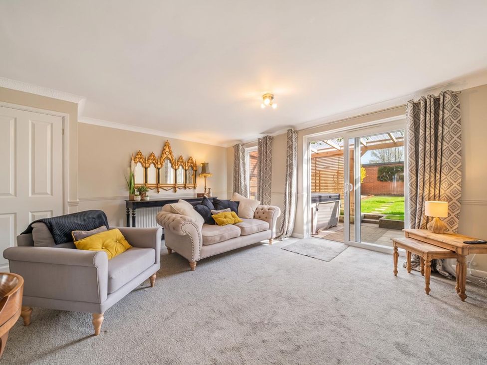 A living room with sofas and patio doors at the property at 