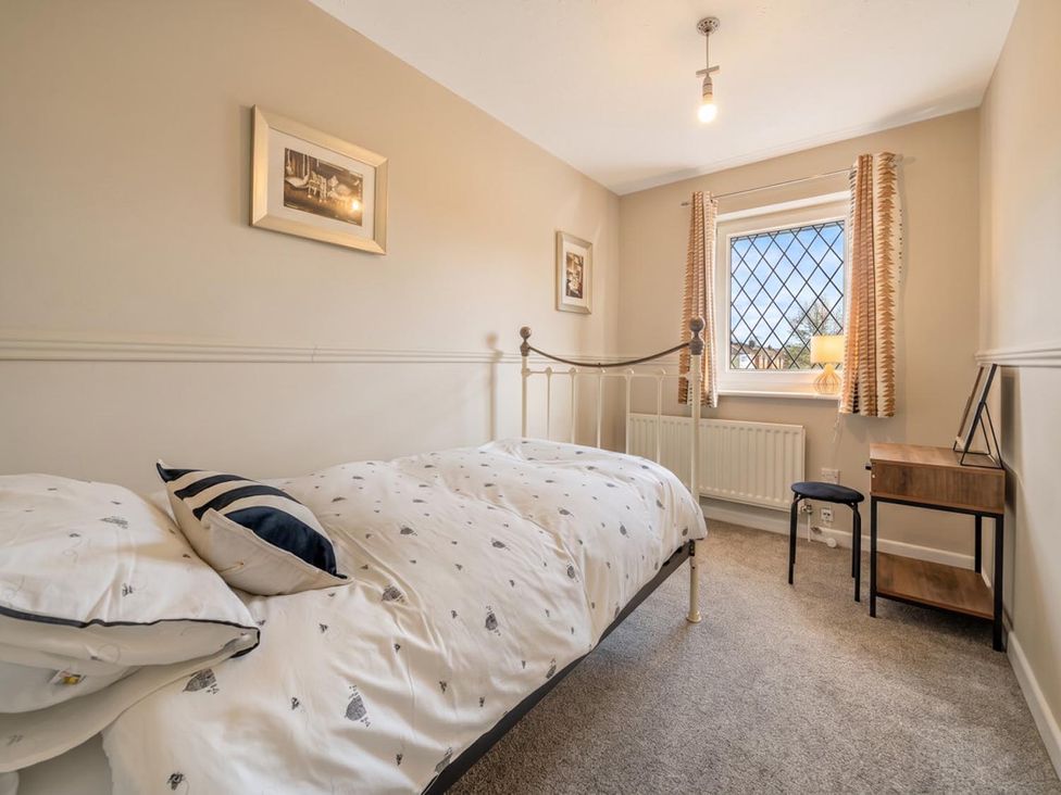 A bedroom with a bed and bedside table at The Old Barn in Manchester