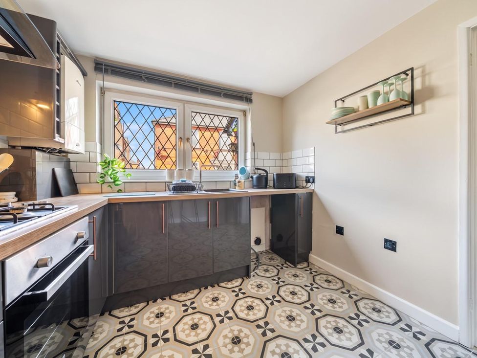 A kitchen with cabinets and a sink at The Old Barn in Manchester