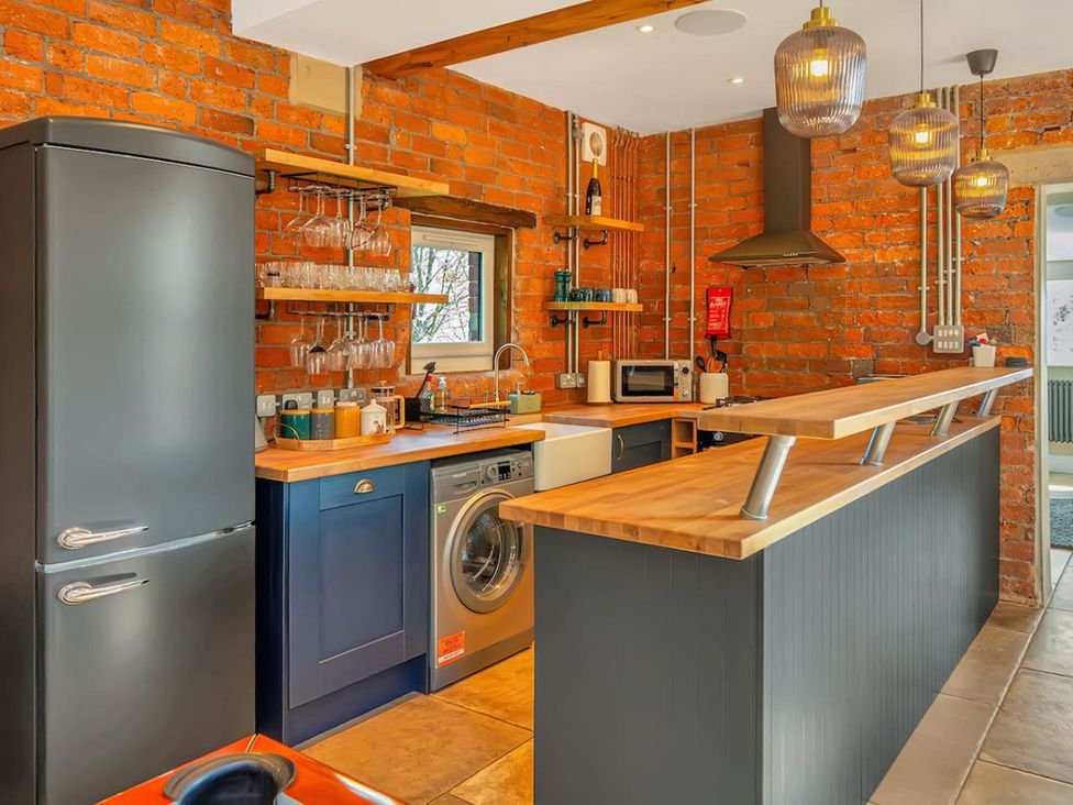A kitchen with appliances and wooden countertops at the property
