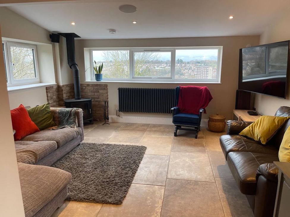 A snug with a sofa and armchair at The Old Barn in Manchester