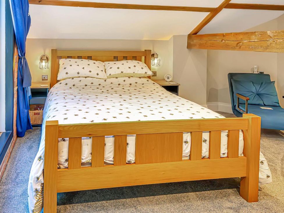 A bedroom with a bed and a chair at the property