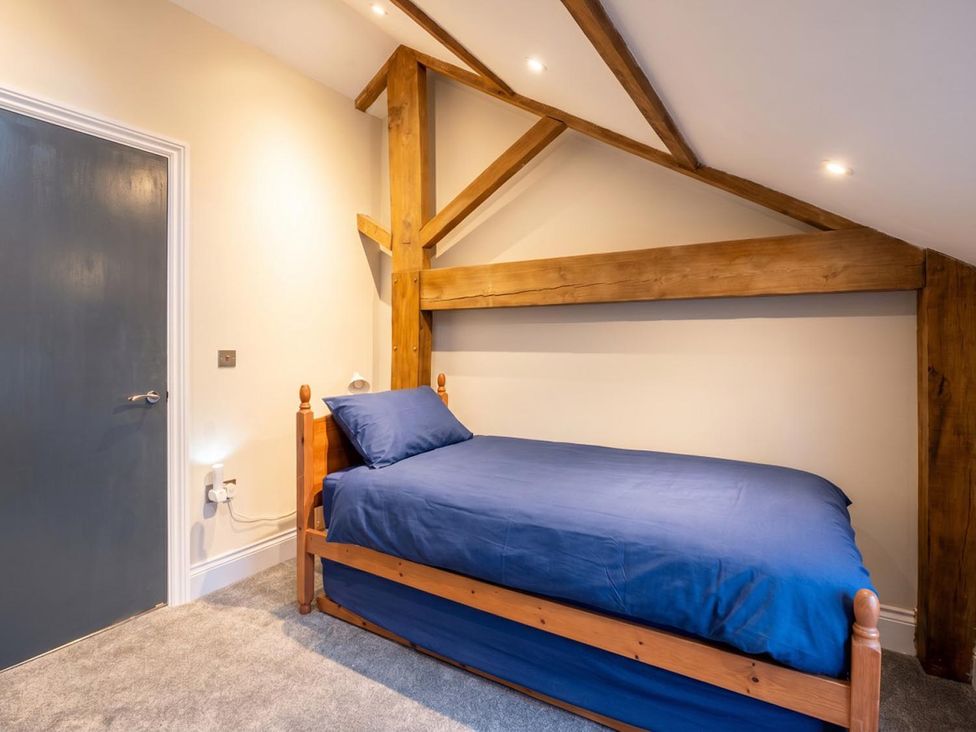 A bedroom with a single bed against a wall at 