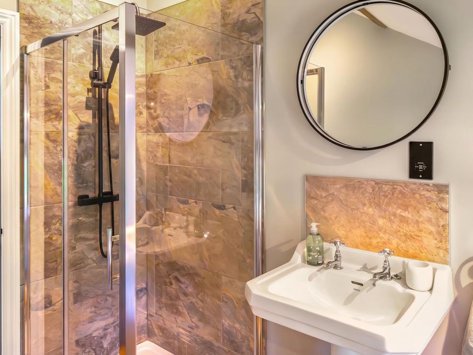 A bathroom with a shower and sink at The Old Barn in Manchester