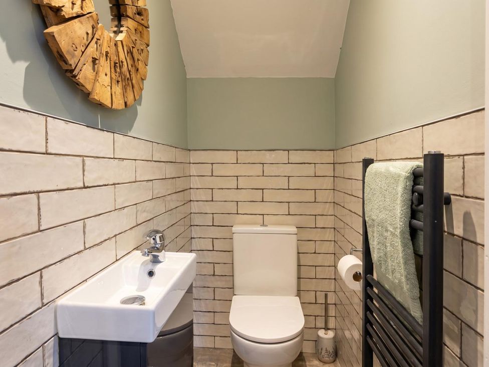 A bathroom with a sink, toilet, and towel radiator at the property