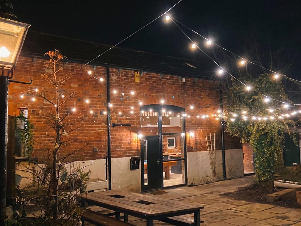 An outdoor area with string lights and a table at the property