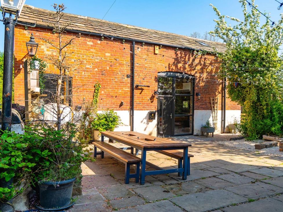 An outdoor area with a table and benches at a property