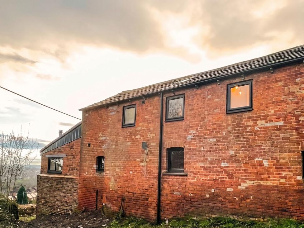 A brick building with windows and a roof at an unspecified location