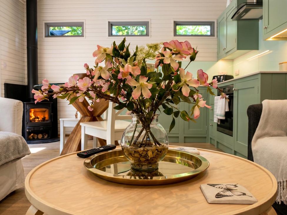 A living room with flowers on a table at The Old Barn in Manchester
