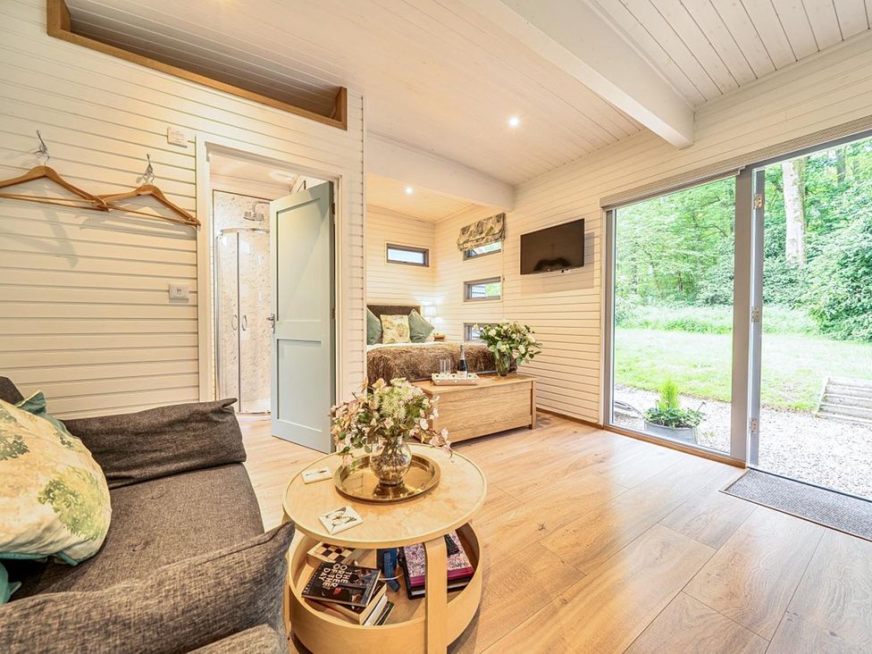 A living room with a sofa and table at the property in a wooded area