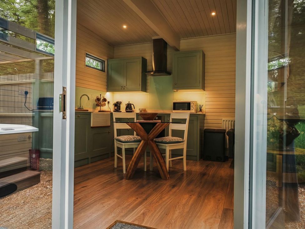A kitchen with cabinets and dining table at a property