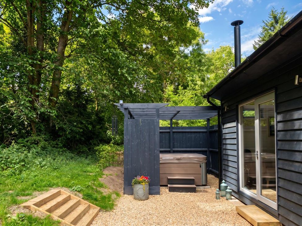 An outdoor area with a hot tub and steps at the property in 