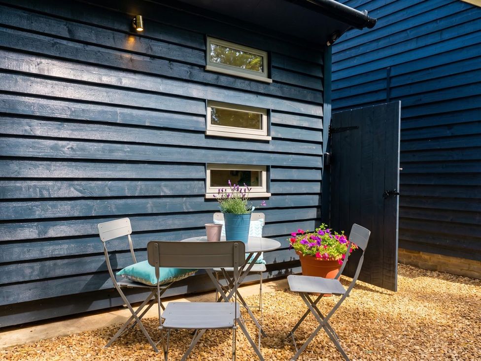 An outdoor seating area with a table and chairs at a property location