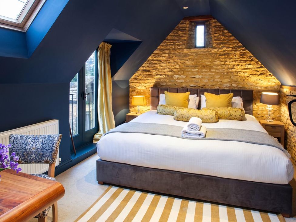 A bedroom with a bed and a table at The Old Barn in Manchester