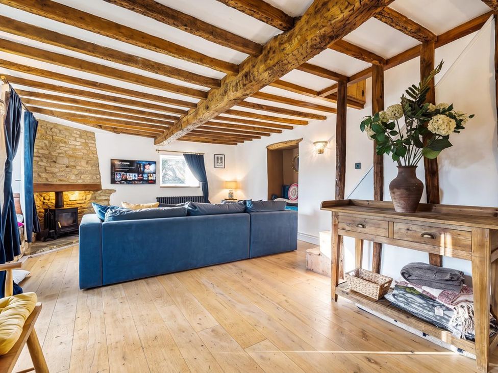A living room with a sofa and fireplace at the property