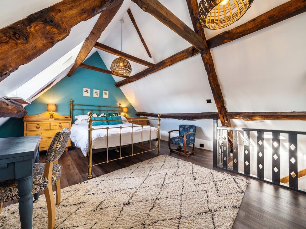 A bedroom with a bed and dresser at The Old Barn in Manchester