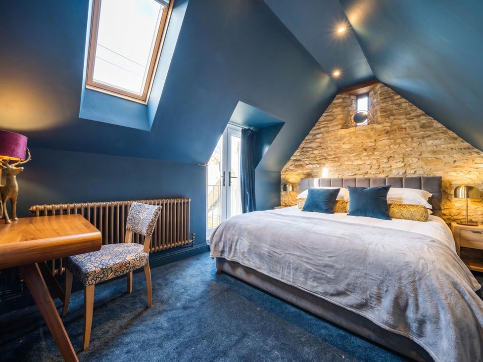 A bedroom with a bed and desk at a property