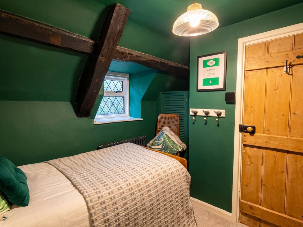 A bedroom with a bed and window at The Old Barn in Manchester
