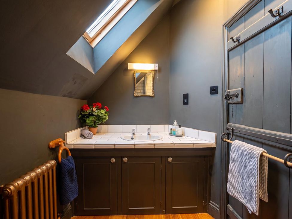 A bathroom with a sink and a mirror at The Old Barn in Manchester