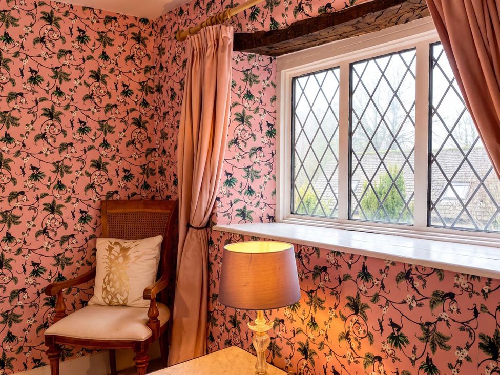 A sitting room with a chair and window at The Old Barn in Manchester