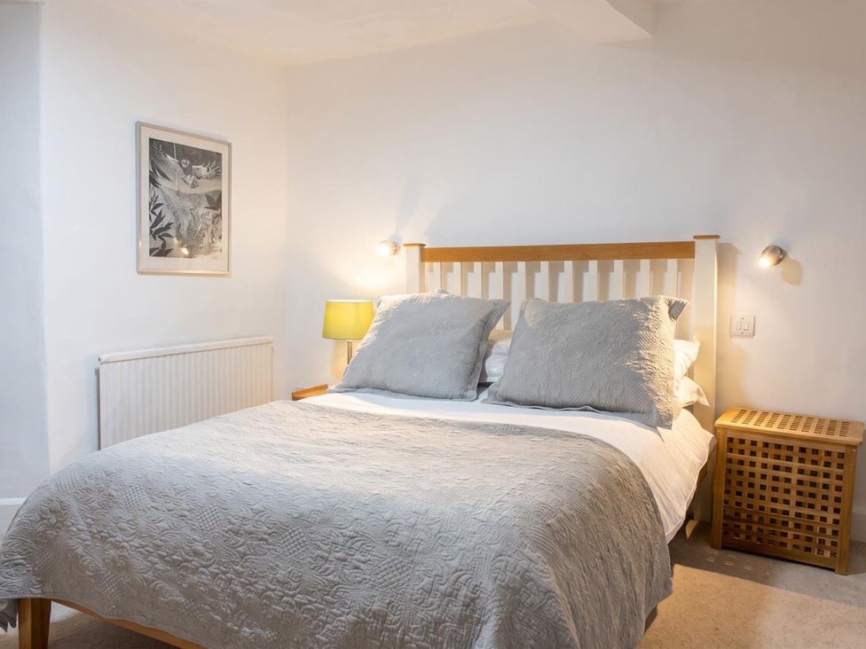 A bedroom with a bed and bedside table at The Old Barn in Manchester