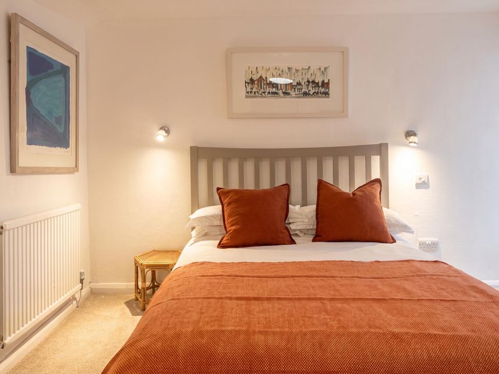 A bedroom with a bed and wall art at The Old Barn in Manchester