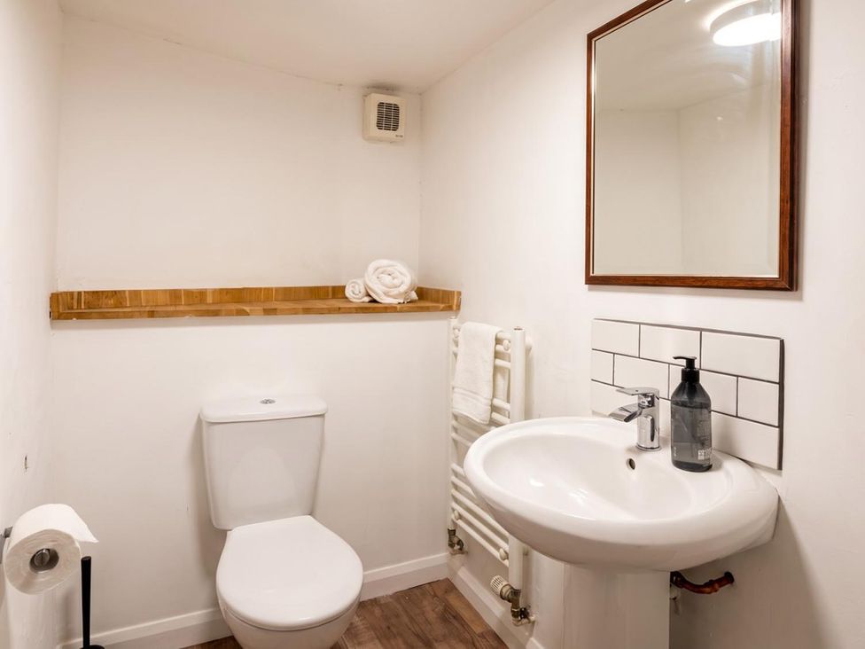 A bathroom with a toilet and sink at The Old Barn in Manchester