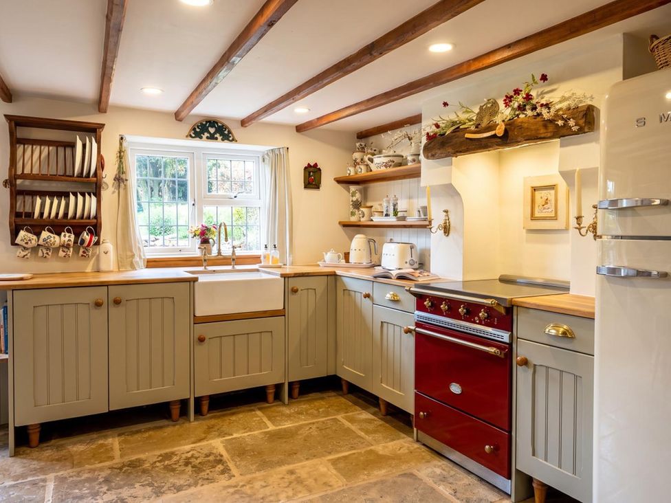 A kitchen with a sink and cooker at a property in an unknown location