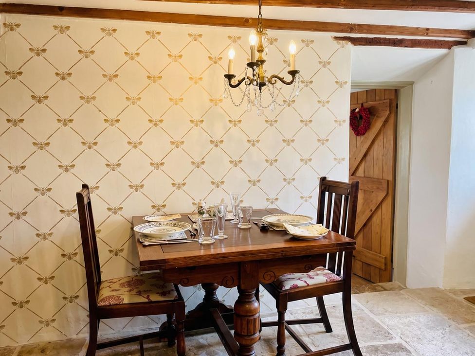 A dining room with a wooden table and chairs at The Old Barn in Manchester