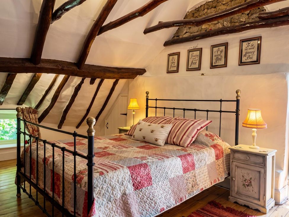 A bedroom with a metal bed and nightstand at The Old Barn in Manchester