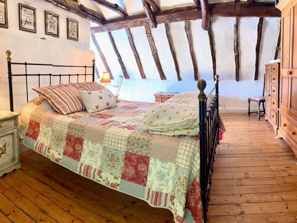 A bedroom with a bed and nightstand at a property