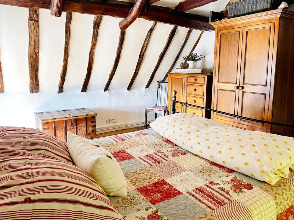 A bedroom with a bed and wooden furniture at the property