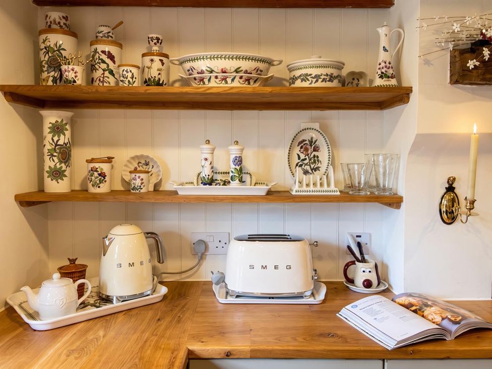 A kitchen with shelves and appliances at the property in 