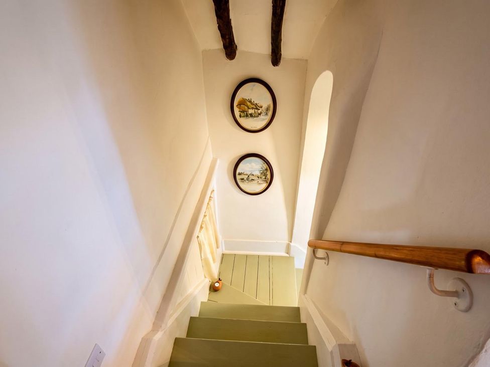 A staircase with paintings on the wall at The Old Barn in Manchester