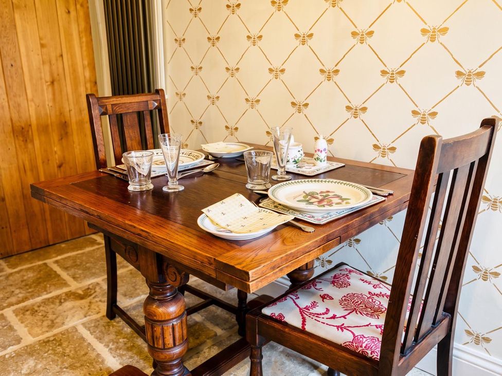 A dining table set with plates and glassware at a dining room