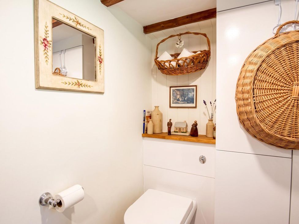 A bathroom with a toilet and decorative items at 