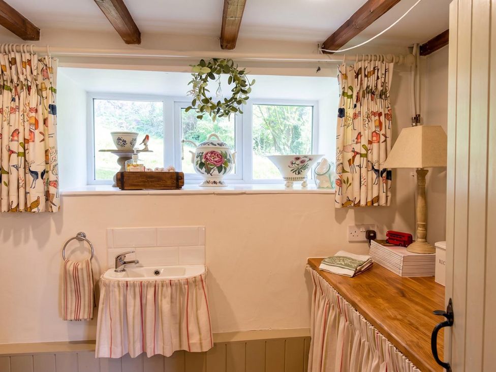 A bathroom with a sink and window at The Old Barn in Manchester