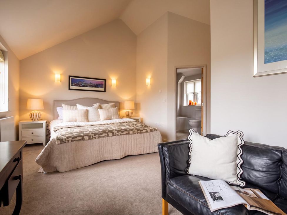 A bedroom with a bed and chair at The Old Barn in Manchester